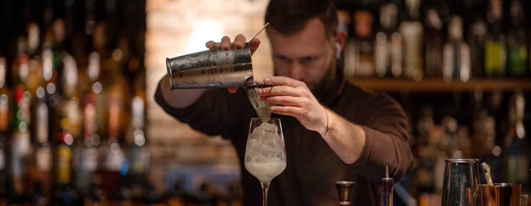 bartender crafting a custom cocktail with house infusions